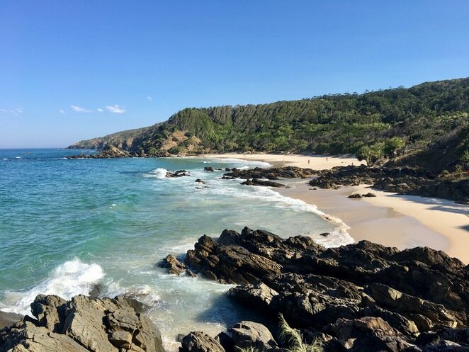Kings Beach, with sand and rocks below the headland